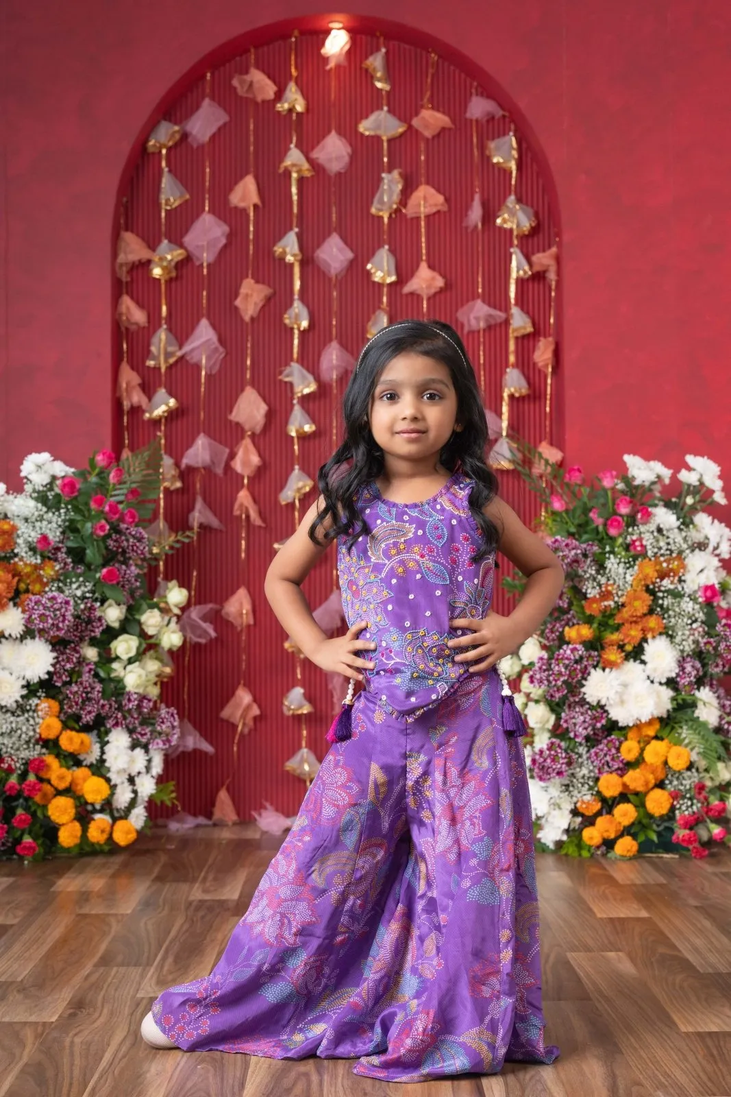 Add a pop of color to your celebrations with this vibrant purple printed top and flared palazzo set